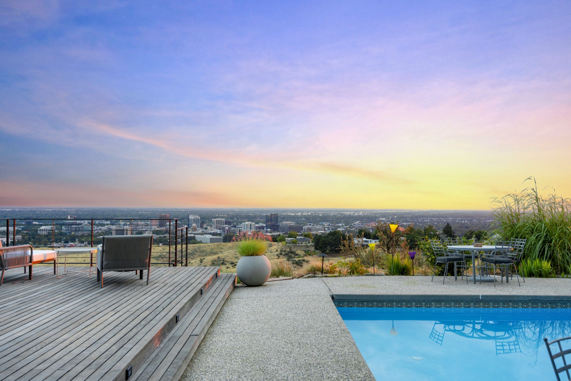 Pool terrace illuminated at dusk overlooking the valley